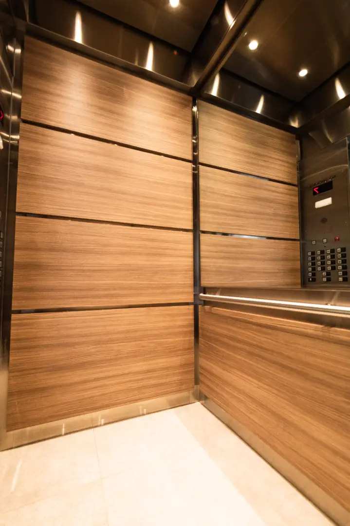 Light Wood Elevator Car Interior with Warm Lighting